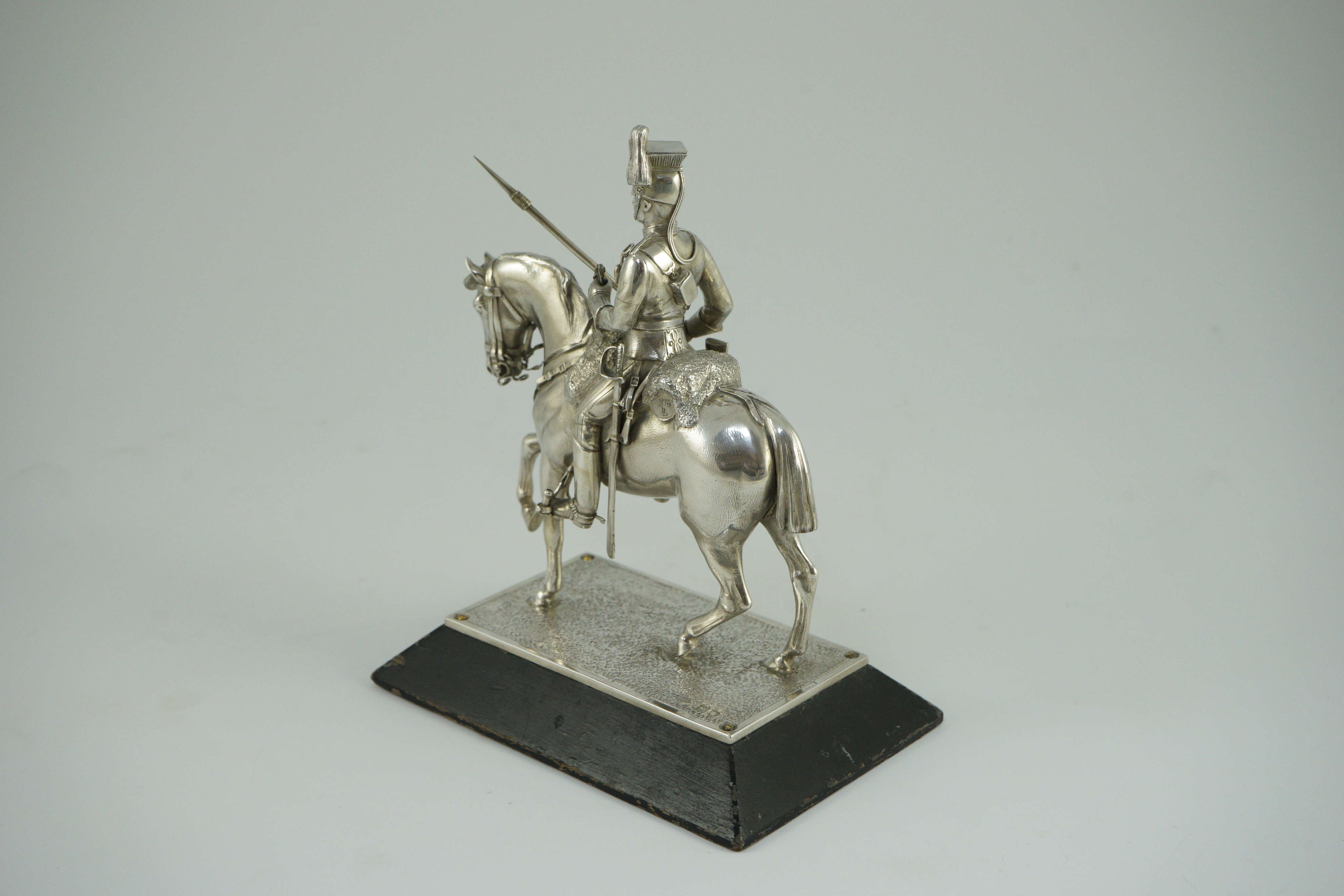 An early 20th century miniature model of a Royal Lancer on horseback, by The Goldsmiths and Silversmiths Co Ltd